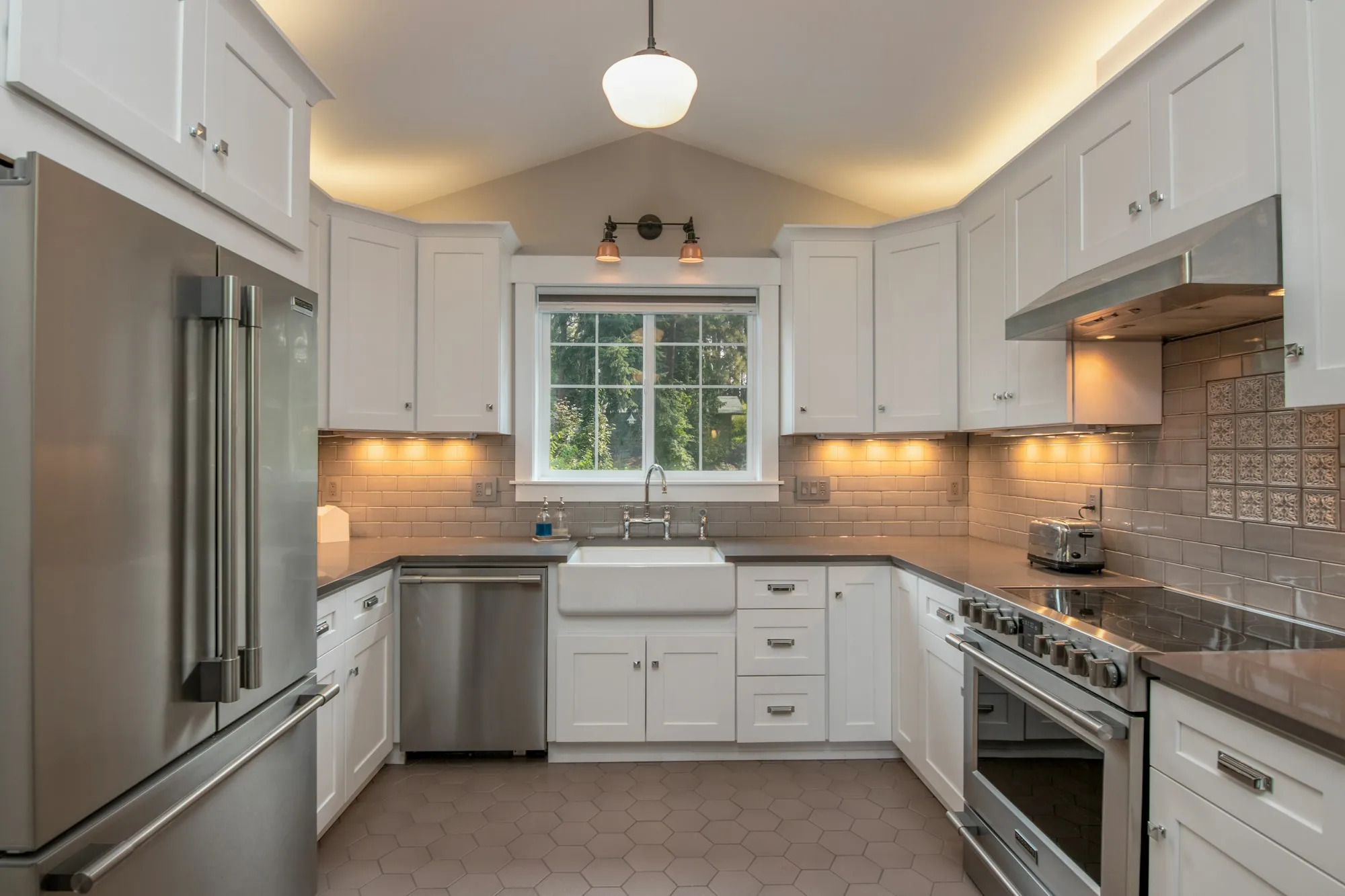 Bright kitchen with under-cabinet lighting along white cabinets