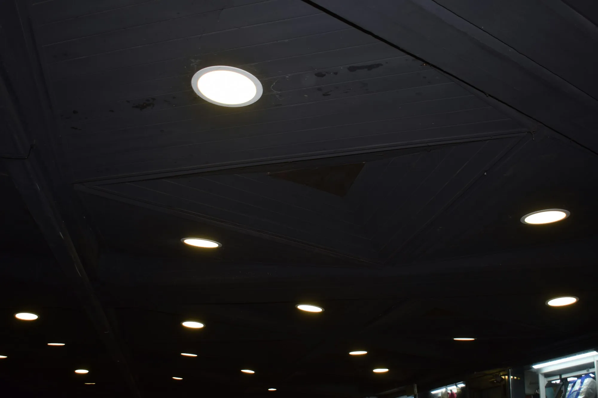 Ceiling of warm recessed downlights in a dark room